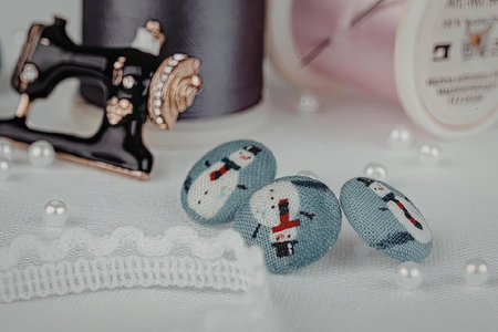 A collection of sewing notions and accessories, including beads, threads, and small denim pouches.