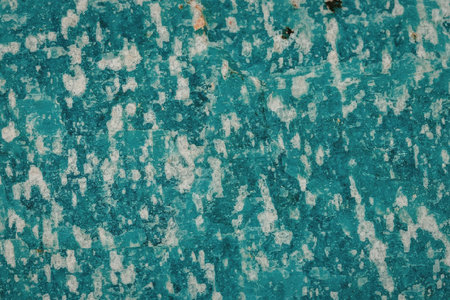 The image displays a teal and white patterned surface. The surface appears to have a textured, rough...