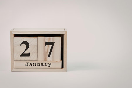 A wooden perpetual calendar displaying the date January 27.