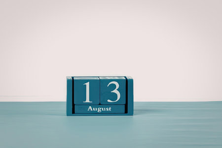 A small blue perpetual calendar displaying the date 13 August.