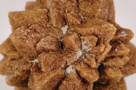 The image displays a close-up view of a brown crystal cluster. The cluster is made up of numerous...