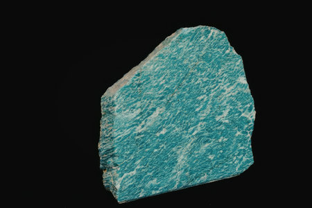 A close-up view of a chunk of turquoise mineral with a rough texture and vibrant blue-green color...
