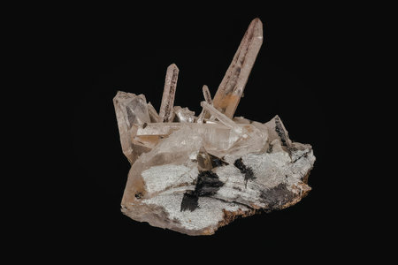 A close-up image of a cluster of quartz crystals on a rock, showcasing their unique shapes and textures.の写真素材