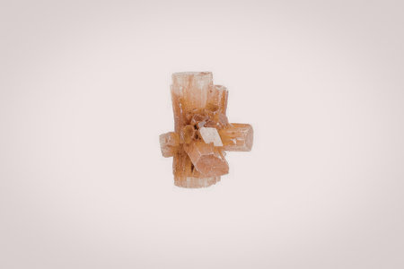 The image features a cluster of orange crystals set against a plain white background. The crystals vary in size and shape, showcasing a range of orange hues.の写真素材