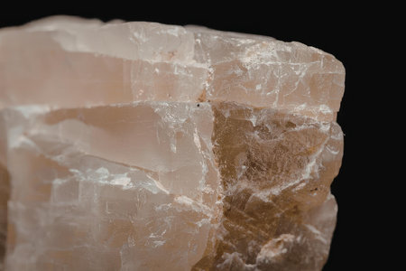 This image presents a detailed close-up of a rough crystal, showcasing its natural texture and color...