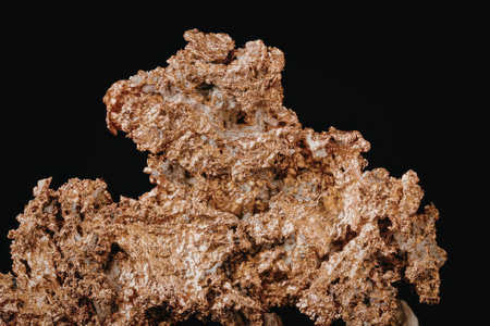 A large copper ore specimen with a rough, porous texture and a reddish-brown color, set against a...