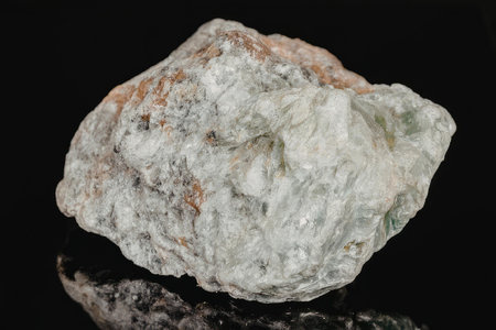This image shows a large mineral rock with a predominantly white and green color scheme. The rock...