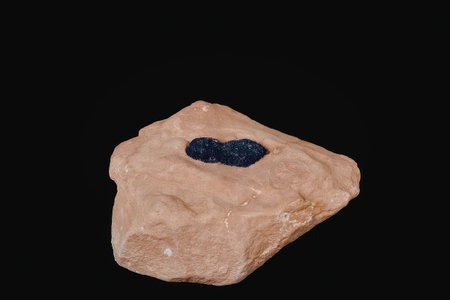 A rock with a blue gemstone embedded in it.