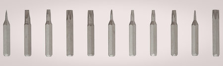 This image displays a set of screwdriver bits arranged horizontally across the top of the frame. The...