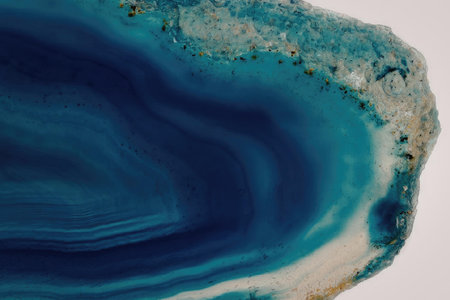 A close-up image of a blue agate mineral, showcasing its vibrant blue color and unique banded...