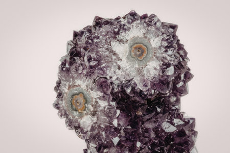A close-up image of a purple amethyst geode with pyrite inclusions, showcasing its crystalline...