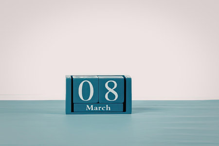 A blue calendar block displaying the date March 8 on a light blue surface with a white background.