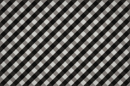 A black and white checkered pattern with diagonal lines, creating a visually striking design.の写真素材