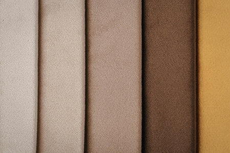 A collection of fabric swatches in various shades of brown, ranging from light beige to dark brown...