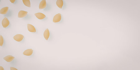 A small pile of golden objects scattered on a plain white surface.