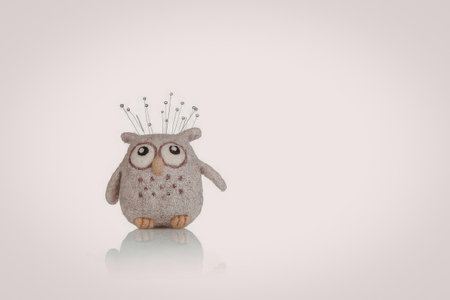 A small owl figurine with a white background