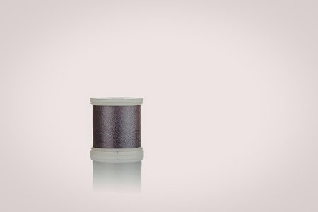 A spool of thread on a white background