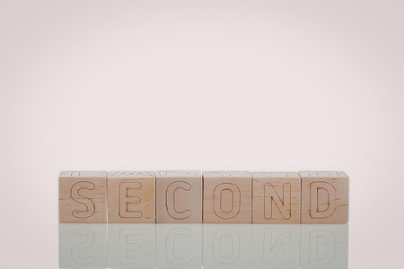 A wooden stamp with the word carved into it, reflected on a white surface.