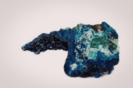 A vibrant blue crystal geode with a unique shape and structure, set against a plain white...