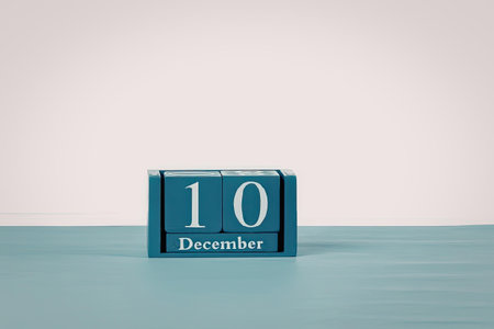 a blue block with the number 10 and december on it sits on a blue surface