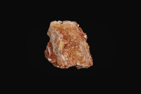 A vibrant red rock with orange and yellow undertones against a black background