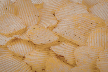 A close-up view of ridged potato chips, showcasing their crispy texture and golden color.