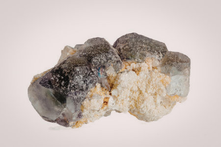 This image features a rough, unpolished amethyst geode with a mix of purple, yellow, and orange...