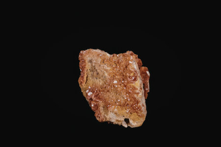 This image presents a detailed view of a rock with a predominantly red and brown coloration. The...