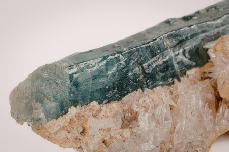 This image presents a detailed view of a raw aquamarine crystal, showcasing its unique texture and...