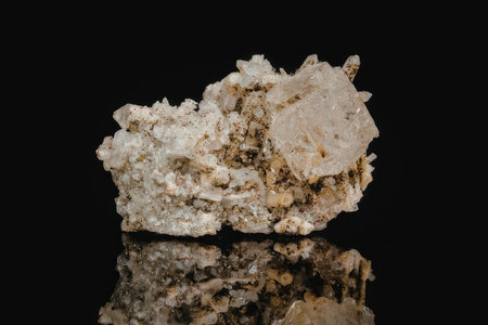 A large crystal rock formation with a rough surface and a mix of white, beige, and brown colors, set...