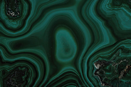A close-up image of a malachite mineral, showcasing its distinctive green swirling patterns and...