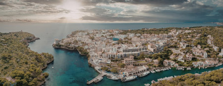 An aerial view of a coastal town with turquoise water and white buildingsの写真素材