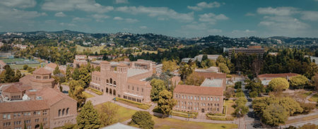 An aerial view of a university campus with red brick buildings and green trees
