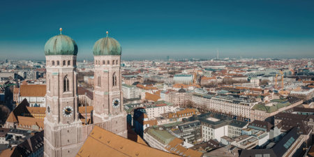 This image presents a stunning aerial view of the Munich cityscape, featuring the iconic twin towers...