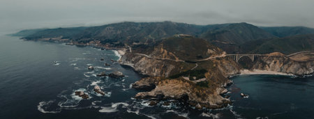 An aerial view of a rugged coastline with numerous boats scattered in the dark blue waters,...