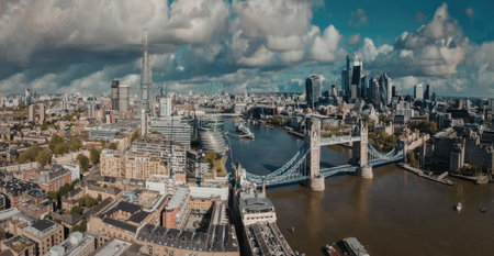 An aerial view of Tower Bridge and the River Thames in London, showcasing the city's skyline with...