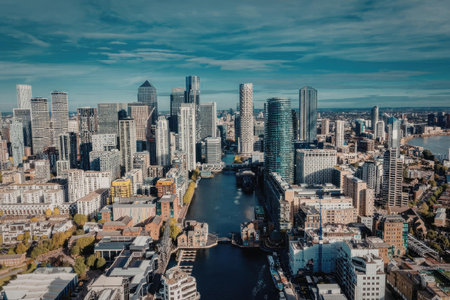 Aerial view of a city with a river running through it, surrounded by tall buildings and skyscrapers...