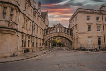 A serene scene of a historic building with an archway leading to another building, set against a...
