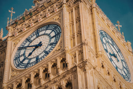 The image shows a close-up view of the iconic Big Ben clock tower, showcasing its intricate architecture and large clock faces.の写真素材