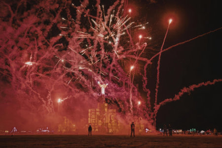 A stunning display of red fireworks exploding in the night sky, creating a vibrant and dynamic...
