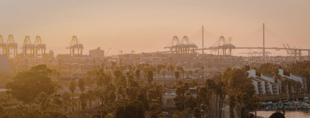 A serene sunset over a cityscape featuring palm trees and a bridge