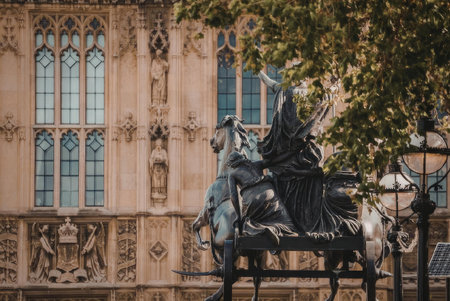 A statue of a man on horseback in front of a large, ornate building with many windows.