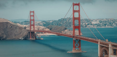 The iconic Golden Gate Bridge spanning over the water with a cityscape in the background.