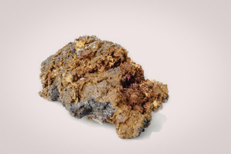 A large piece of pyrite rock with a rough texture and shiny golden flecks on a white background.