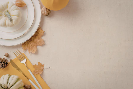a seasonal table setting with a plate, pumpkin, and fall leaves