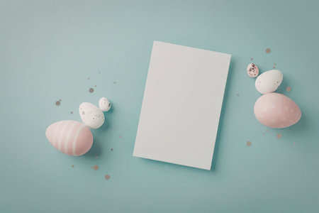 A flat lay of pink and white Easter eggs, a blank white card, and pastel-colored background with...