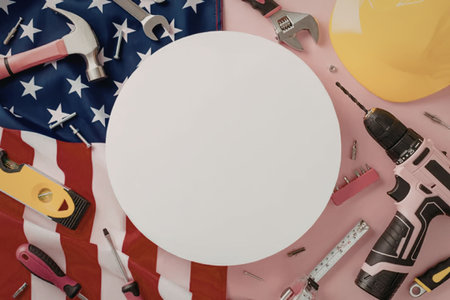 A collection of construction tools and a hard hat on an American flag background