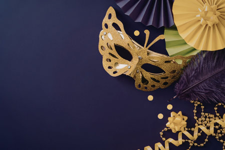 A gold Mardi Gras mask with purple, green, and yellow decorations on a purple background
