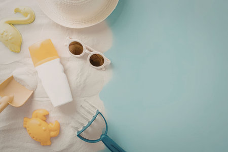 A collection of summer vacation essentials laid out on a beach towel