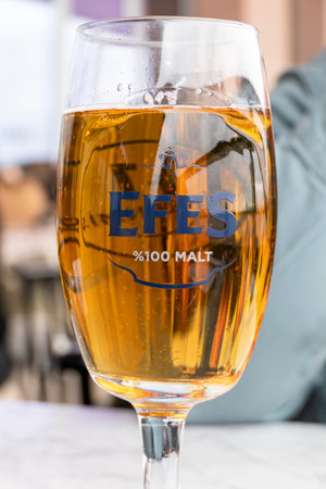 Traditional Turkish Efes Beer in a glass served in a restaurantのeditorial素材